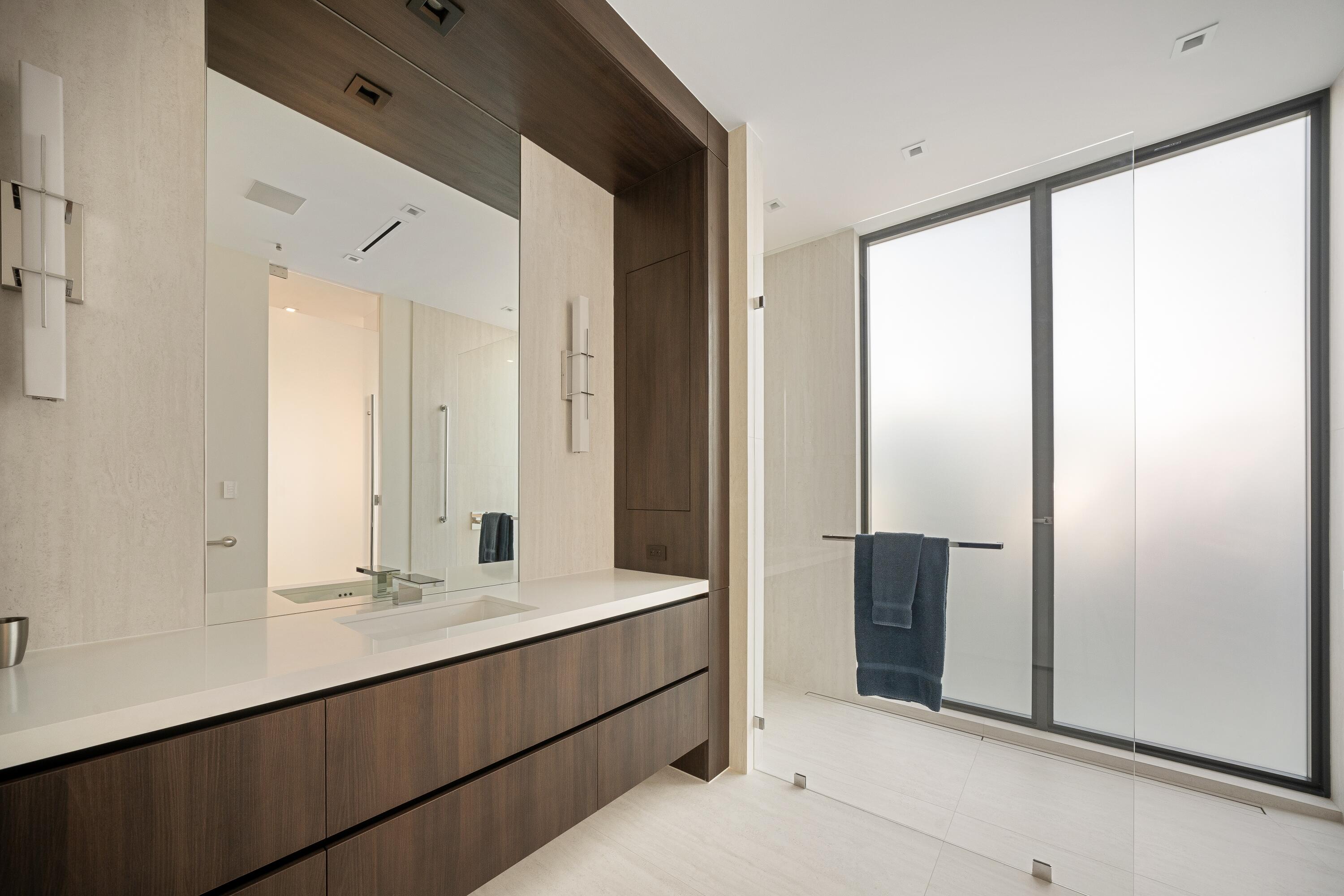 5211 Pennock Point Road Jupiter, FL 33458 - Photo 45 of 69 a bathroom with a double vanity sink and mirror