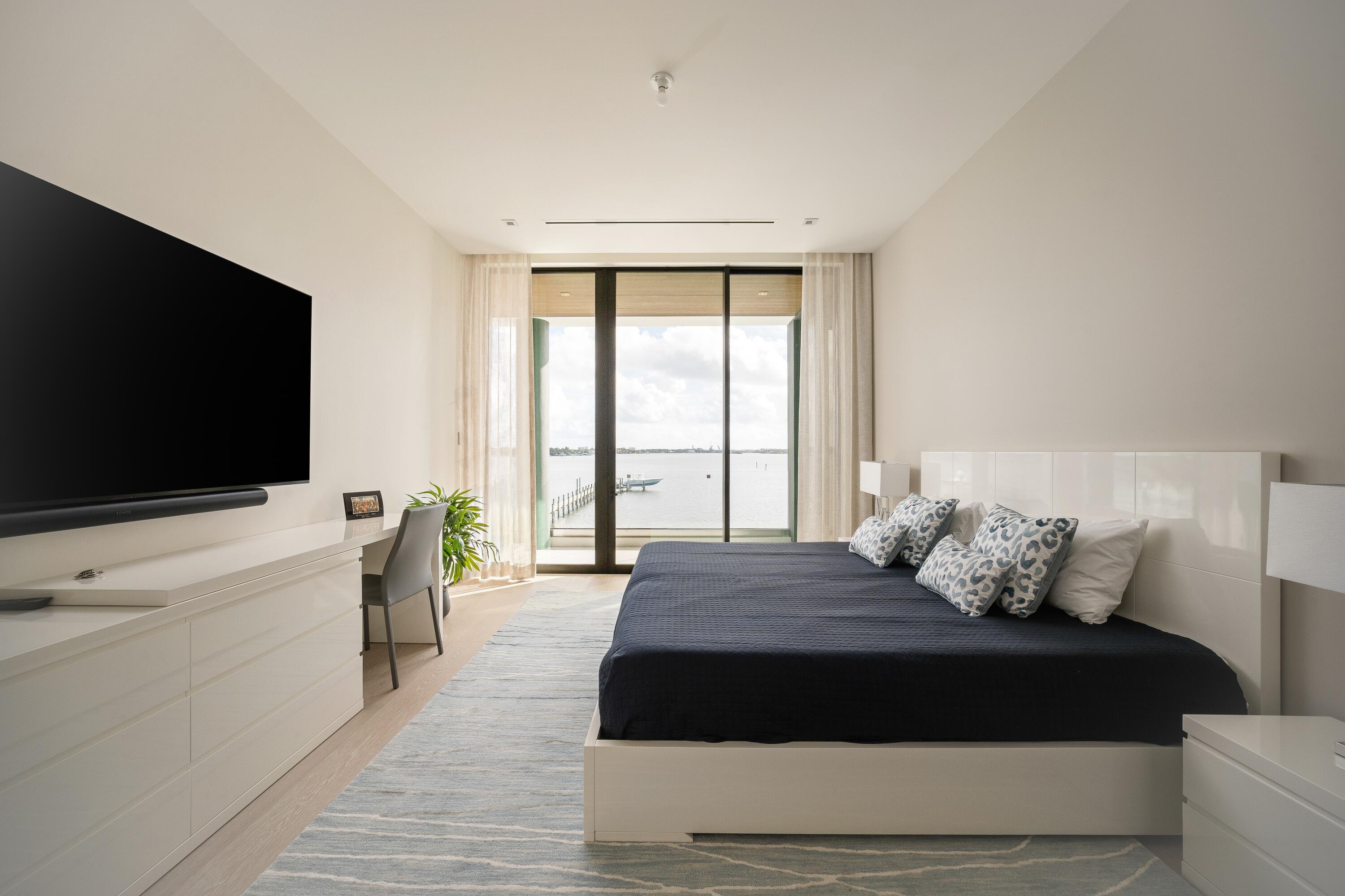 5211 Pennock Point Road Jupiter, FL 33458 - Photo 50 of 69 a bedroom with a bed and a flat screen tv