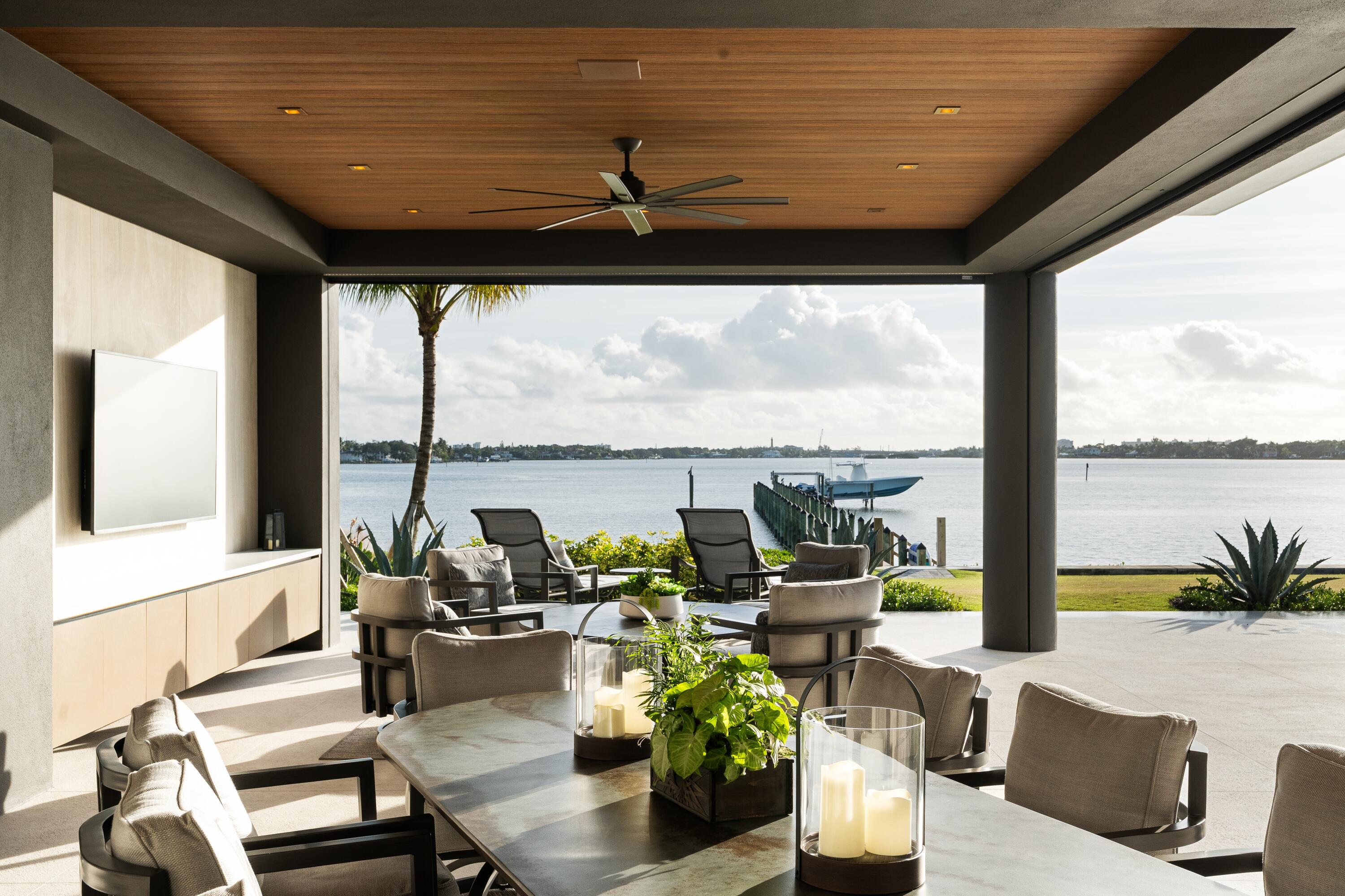 5211 Pennock Point Road Jupiter, FL 33458 - Photo 58 of 69 a living room with patio furniture and floor to ceiling windows