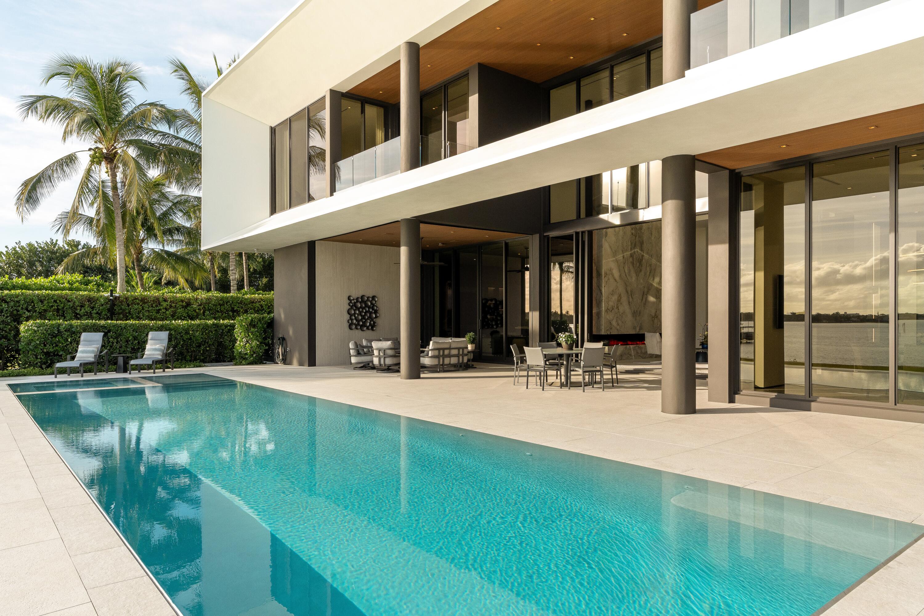 5211 Pennock Point Road Jupiter, FL 33458 - Photo 65 of 69 a view of a house with a swimming pool and porch with furniture