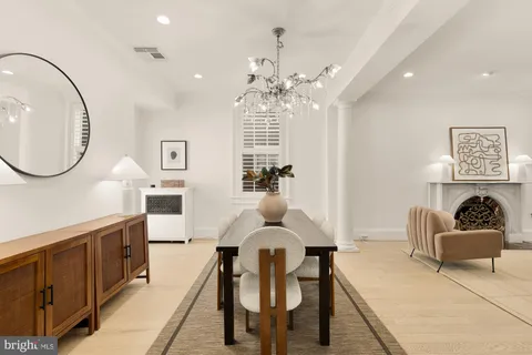 a living room with furniture a fireplace a potted plant and a fireplace