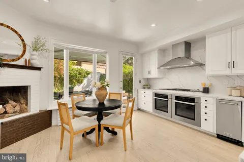 a kitchen with stainless steel appliances white cabinets and a stove