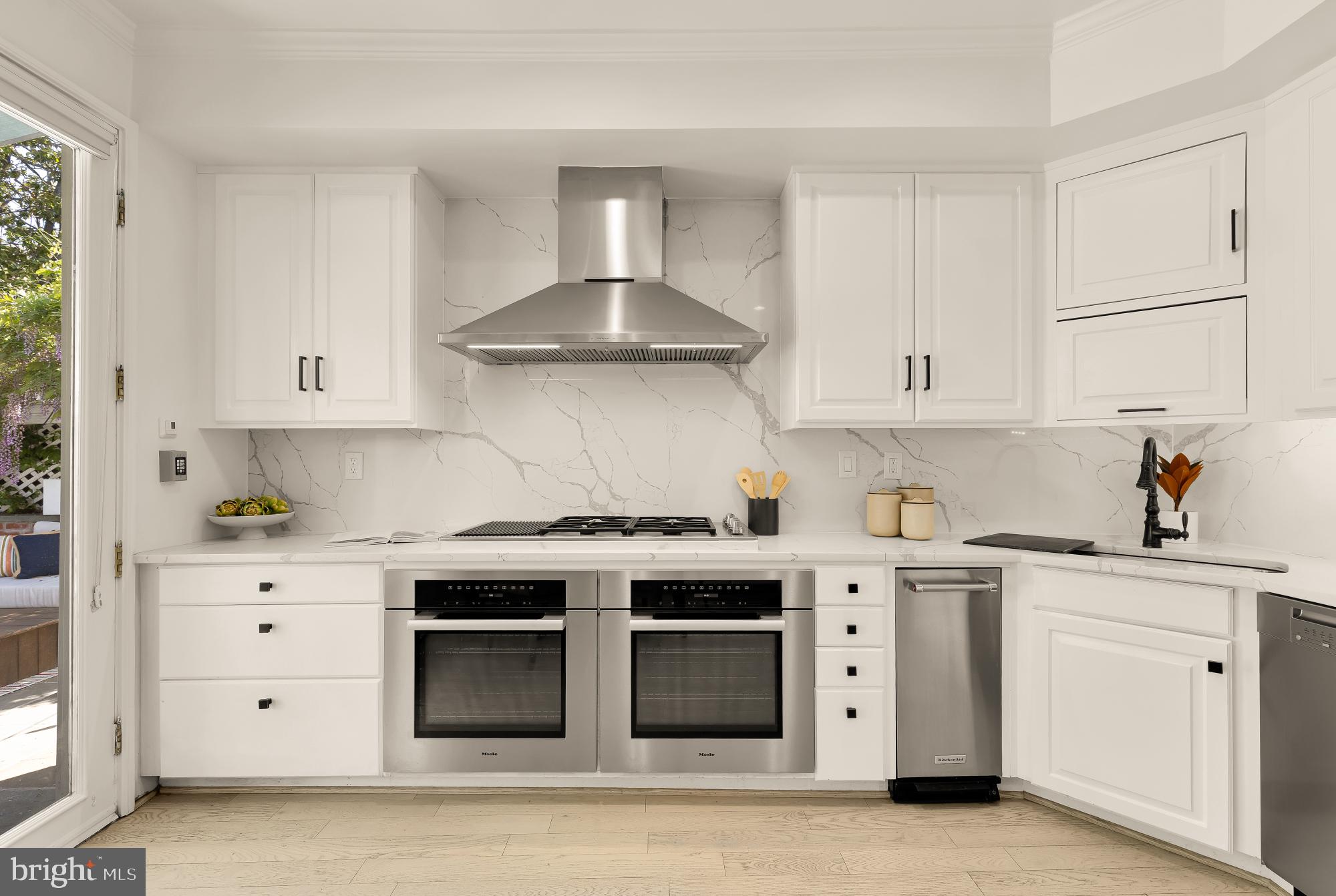 3249 P Street Northwest Washington, DC 20007 - Photo 16 of 63 a kitchen with stainless steel appliances granite countertop a stove and white cabinets