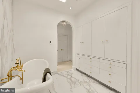 a bathroom with a sink mirror and a shower