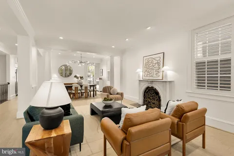 a living room with furniture fireplace and window
