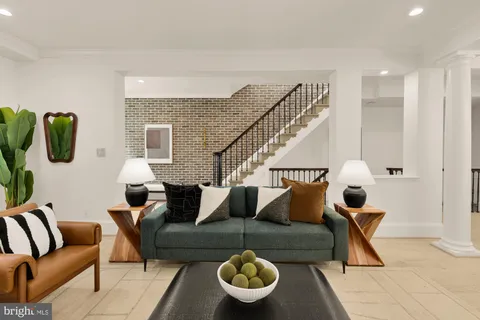 a view of a a dining room with furniture window and wooden floor