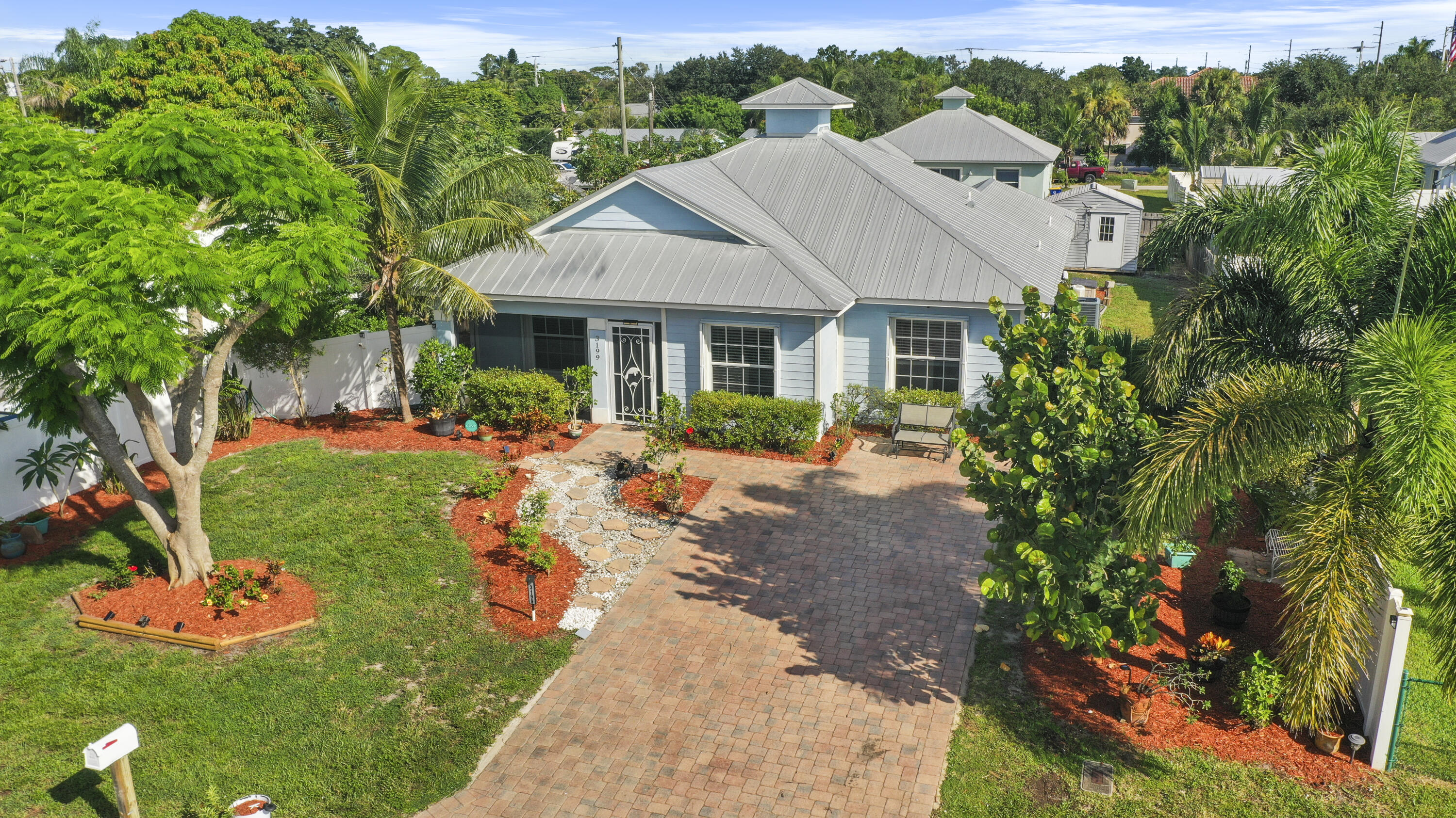 a view of a house with a yard and garden