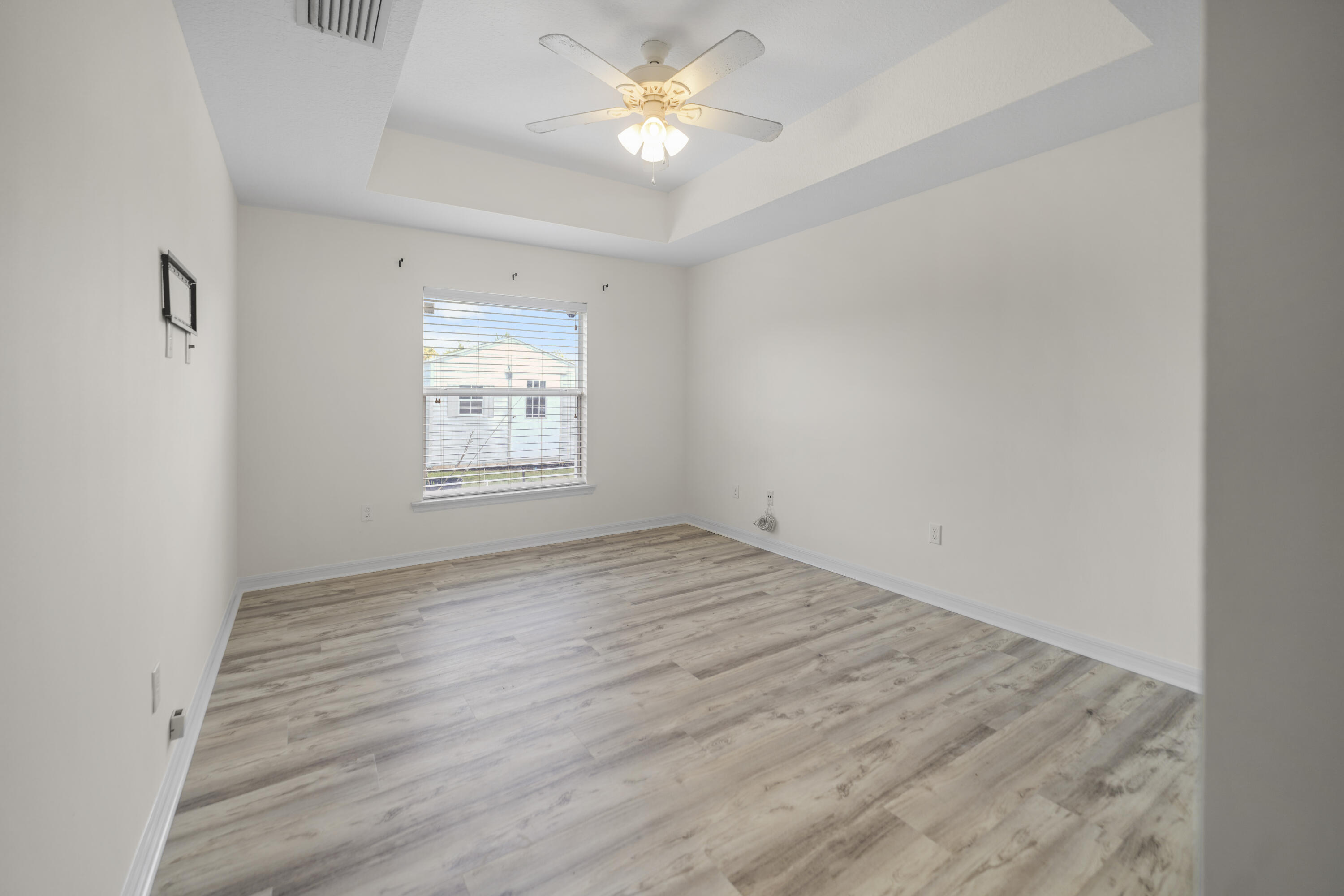 3199 Southeast Lime Tree Trail Stuart, FL 34997 - Photo 15 of 34 wooden floor in an empty room with a window