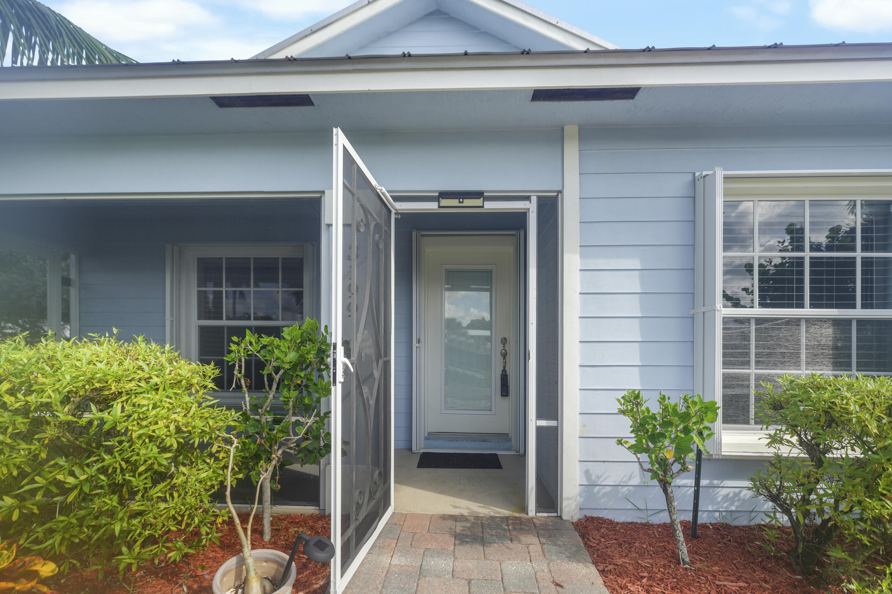 3199 Southeast Lime Tree Trail Stuart, FL 34997 - Photo 4 of 34 a view of a entryway door front of house