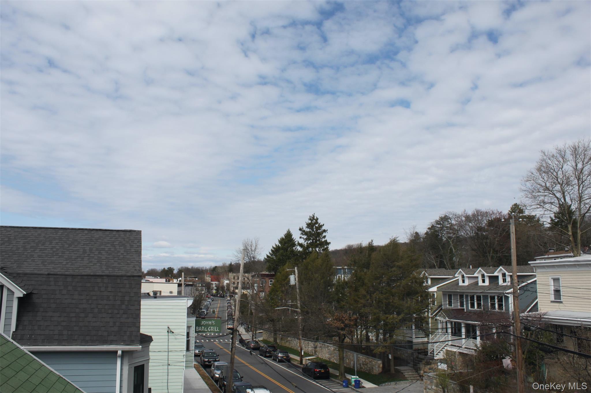 451 Warburton Avenue, Unit 3 Hastings-on-Hudson, NY 10706 - Photo 13 of 16 a terrace with outdoor seating and city view