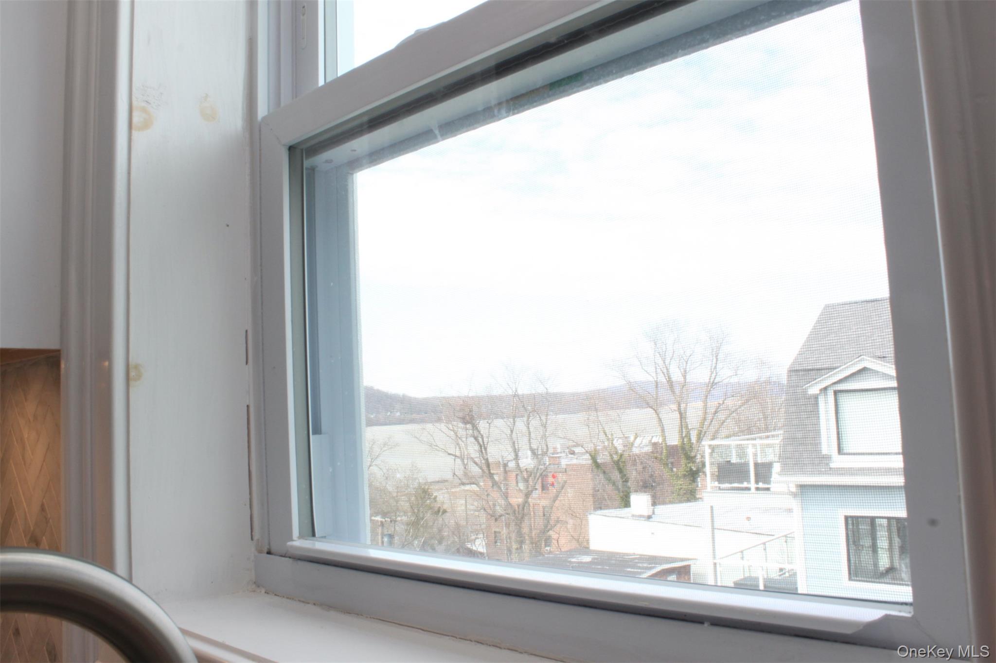 451 Warburton Avenue, Unit 3 Hastings-on-Hudson, NY 10706 - Photo 15 of 16 a view of a glass building from a window