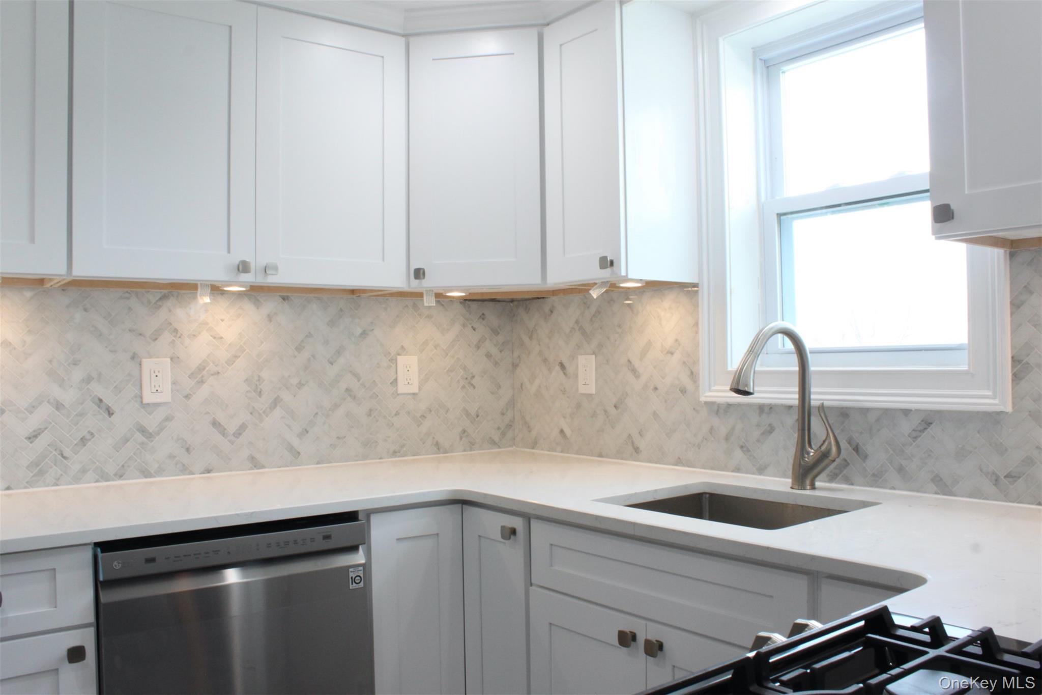 451 Warburton Avenue, Unit 3 Hastings-on-Hudson, NY 10706 - Photo 5 of 16 a kitchen with a sink and cabinets