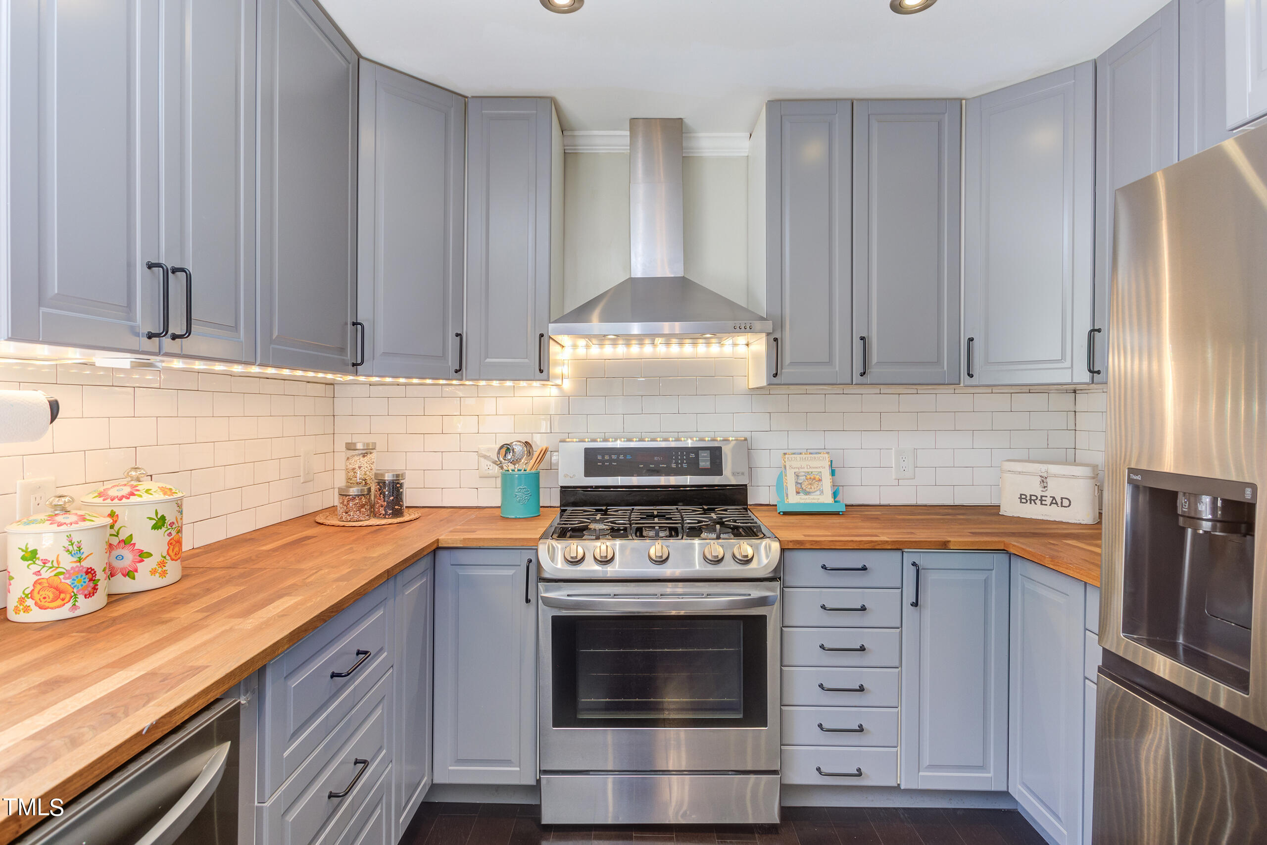 30 Sandstone Ridge Drive Durham, NC 27713 - Photo 19 of 65 a kitchen with stainless steel appliances a stove and a refrigerator