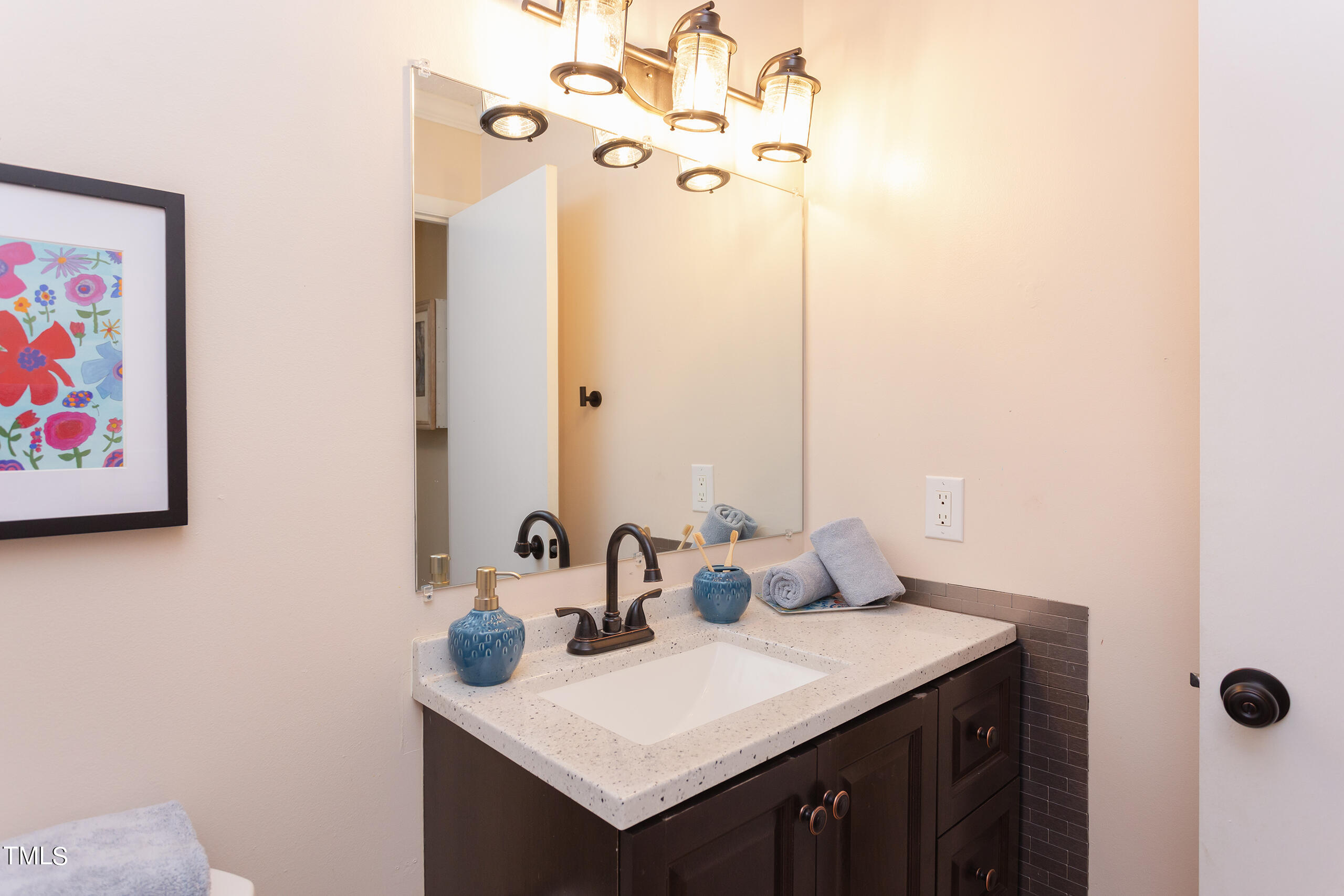 30 Sandstone Ridge Drive Durham, NC 27713 - Photo 49 of 65 a bathroom with a sink vanity and a mirror