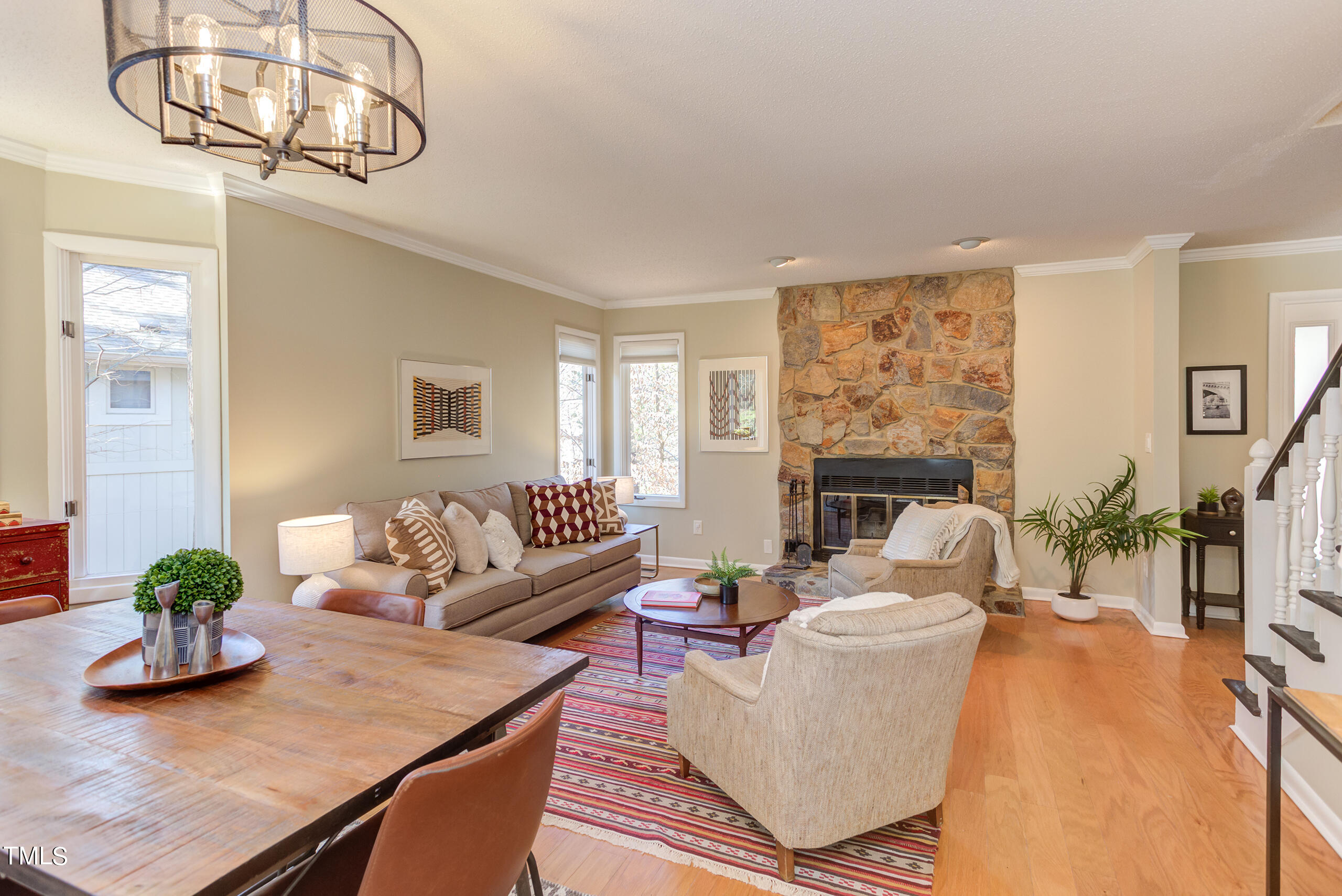 30 Sandstone Ridge Drive Durham, NC 27713 - Photo 10 of 65 a living room with furniture a fireplace and a chandelier