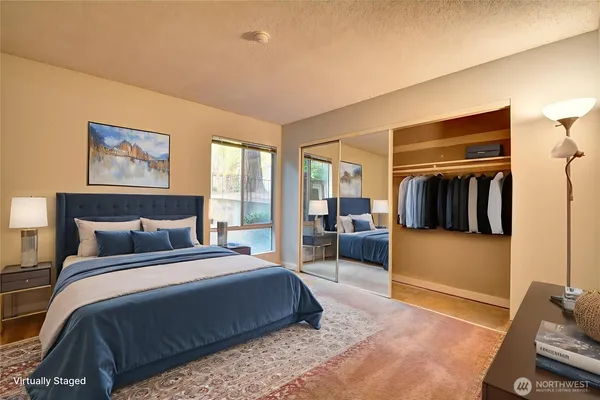 a bedroom with a bed and glass walk in closet