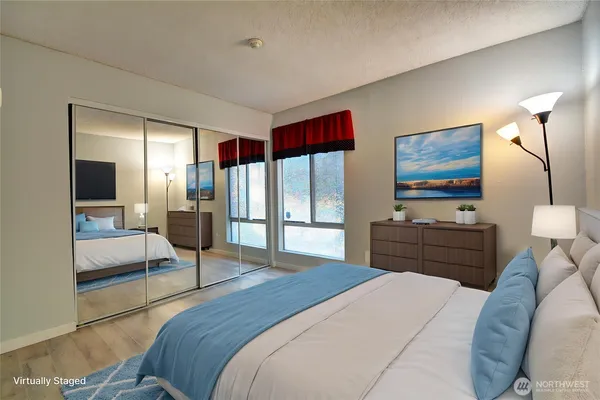 a bedroom with a bed and wooden floor