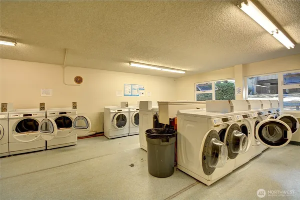 a utility room with multiple dryer and washer