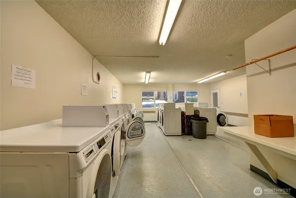 a kitchen with a white table chairs in it and wooden floors