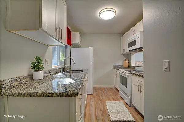 a kitchen with stainless steel appliances granite countertop a sink and a stove