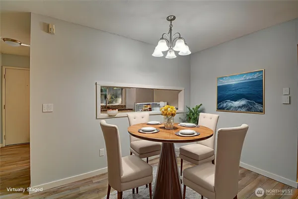 a view of a dining room with furniture wooden floor and a chandelier
