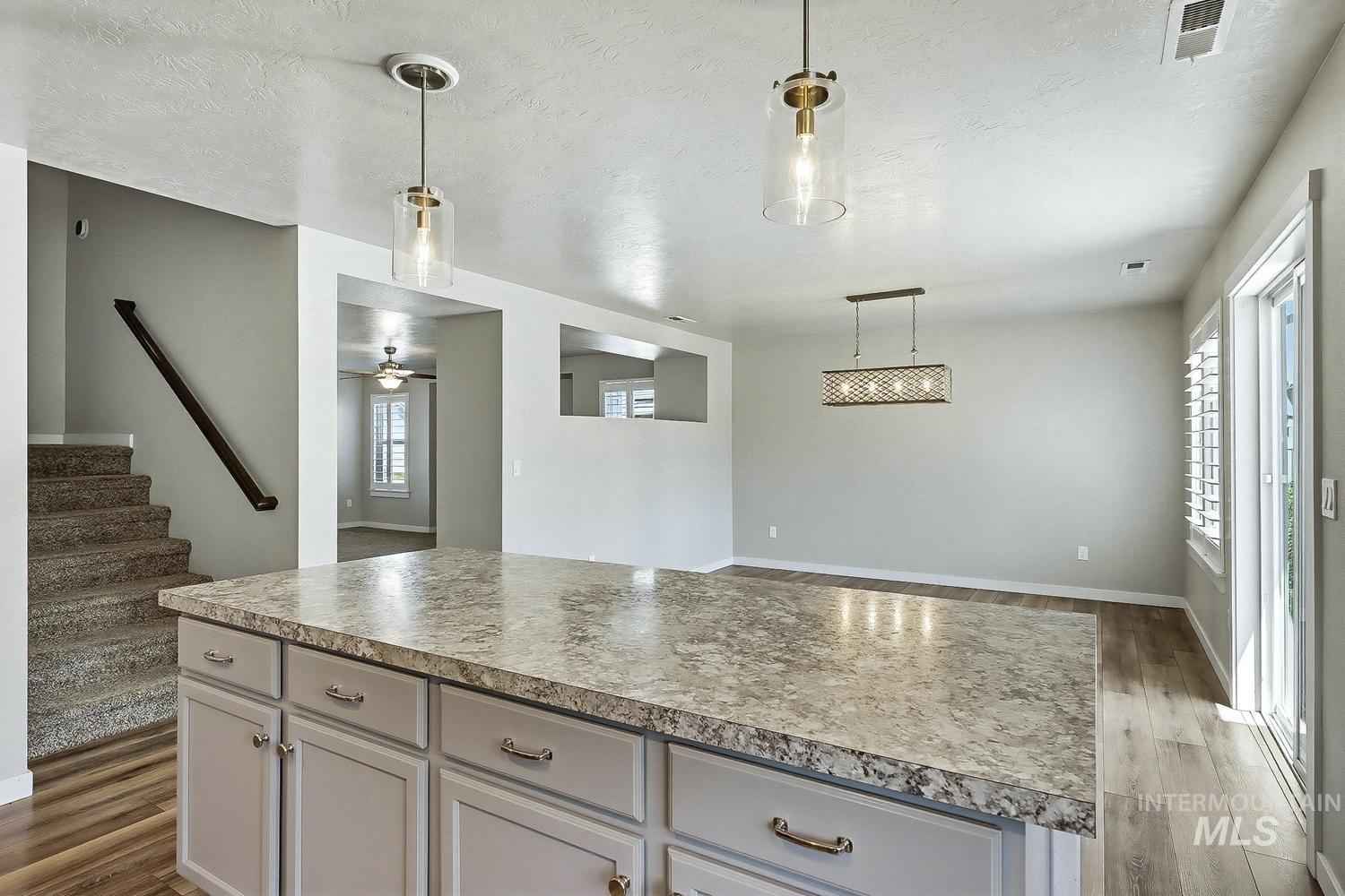 846 North Hidden View Way Star, ID 83669 - Photo 15 of 49 Kitchen island featuring a laminate countertop and light gray cabinetry