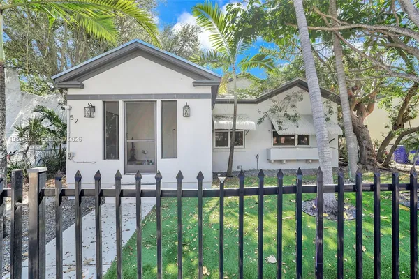 a view of a house with wooden fence and floor