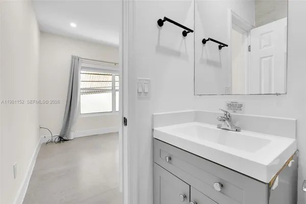 a view of empty room with window and front door
