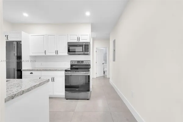 a view of an empty room with a chandelier