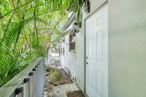 a view of a house with a tree beside it