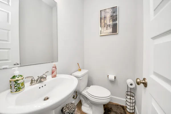 a bathroom with a sink and mirror with toilet