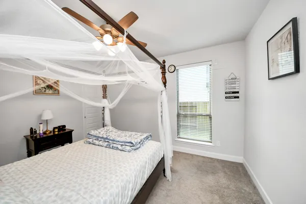 a bedroom with a bed and a window