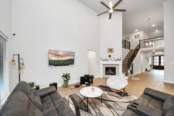 a living room with furniture a fireplace and a flat screen tv