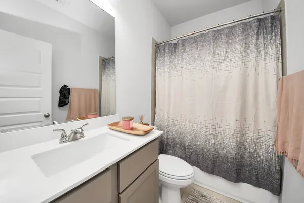 a work room with furniture and a chandelier fan