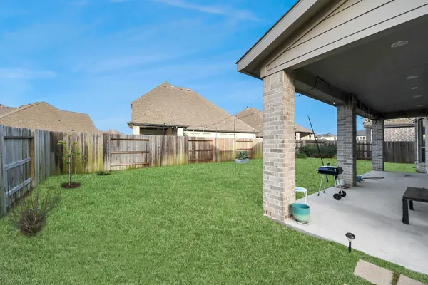 a view of a house with a yard and sitting area