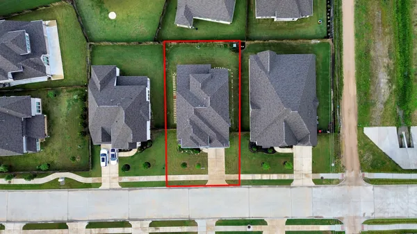 an aerial view of multiple houses with yard