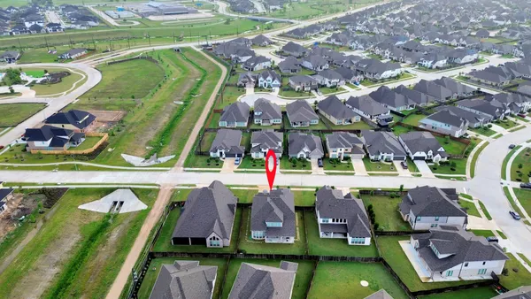 a view of swimming pool with a patio and a garden