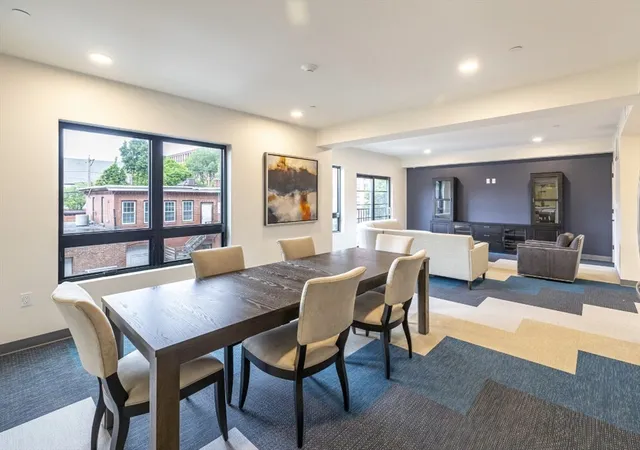 a view of a dining room with furniture large windows and wooden floor