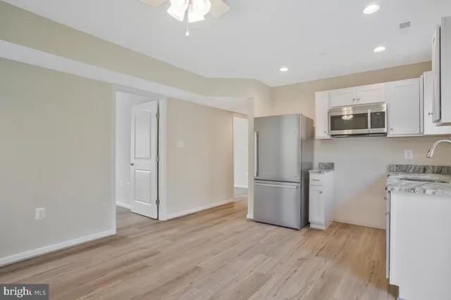 a kitchen with a refrigerator a stove top oven a sink and dishwasher