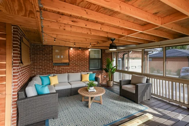 a view of a patio with couches and a table and chairs
