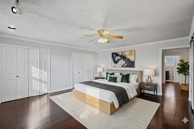 a bedroom with a bed and a chandelier