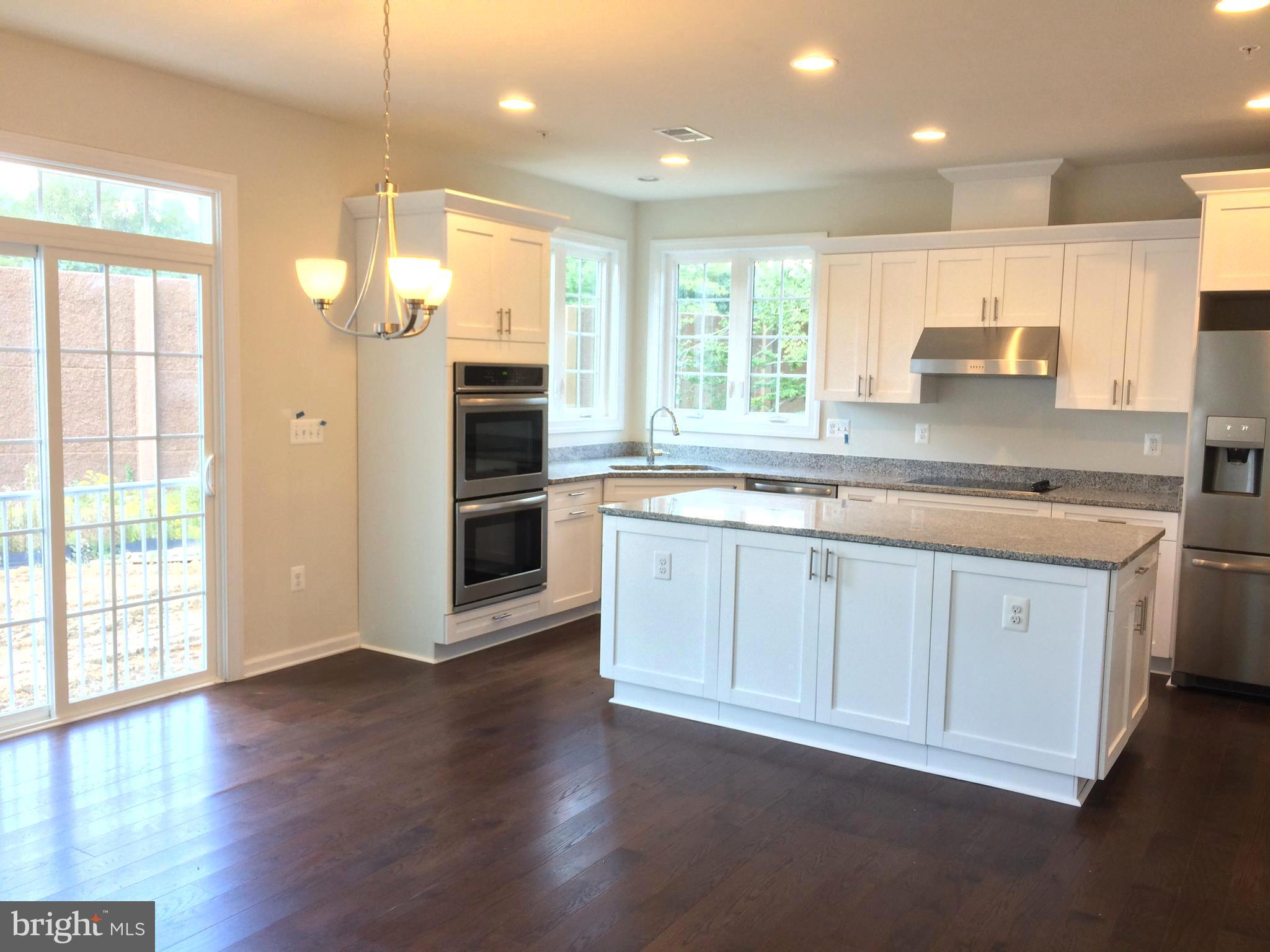 6510 Lawyers Hill Road Elkridge, MD 21075 - Photo 2 of 28 a large kitchen with stainless steel appliances granite countertop a large stove a sink and a refrigerator