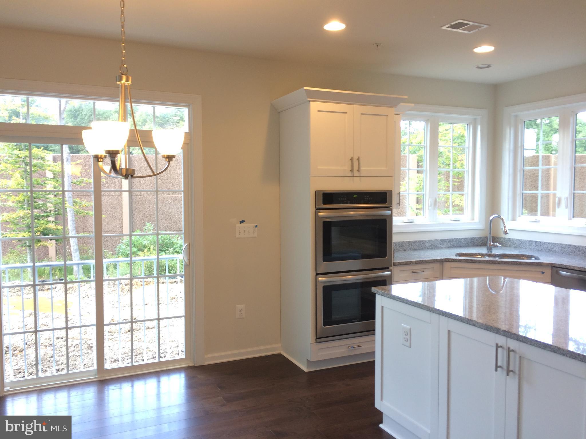 6510 Lawyers Hill Road Elkridge, MD 21075 - Photo 3 of 28 a kitchen with stainless steel appliances granite countertop a stove and a large window