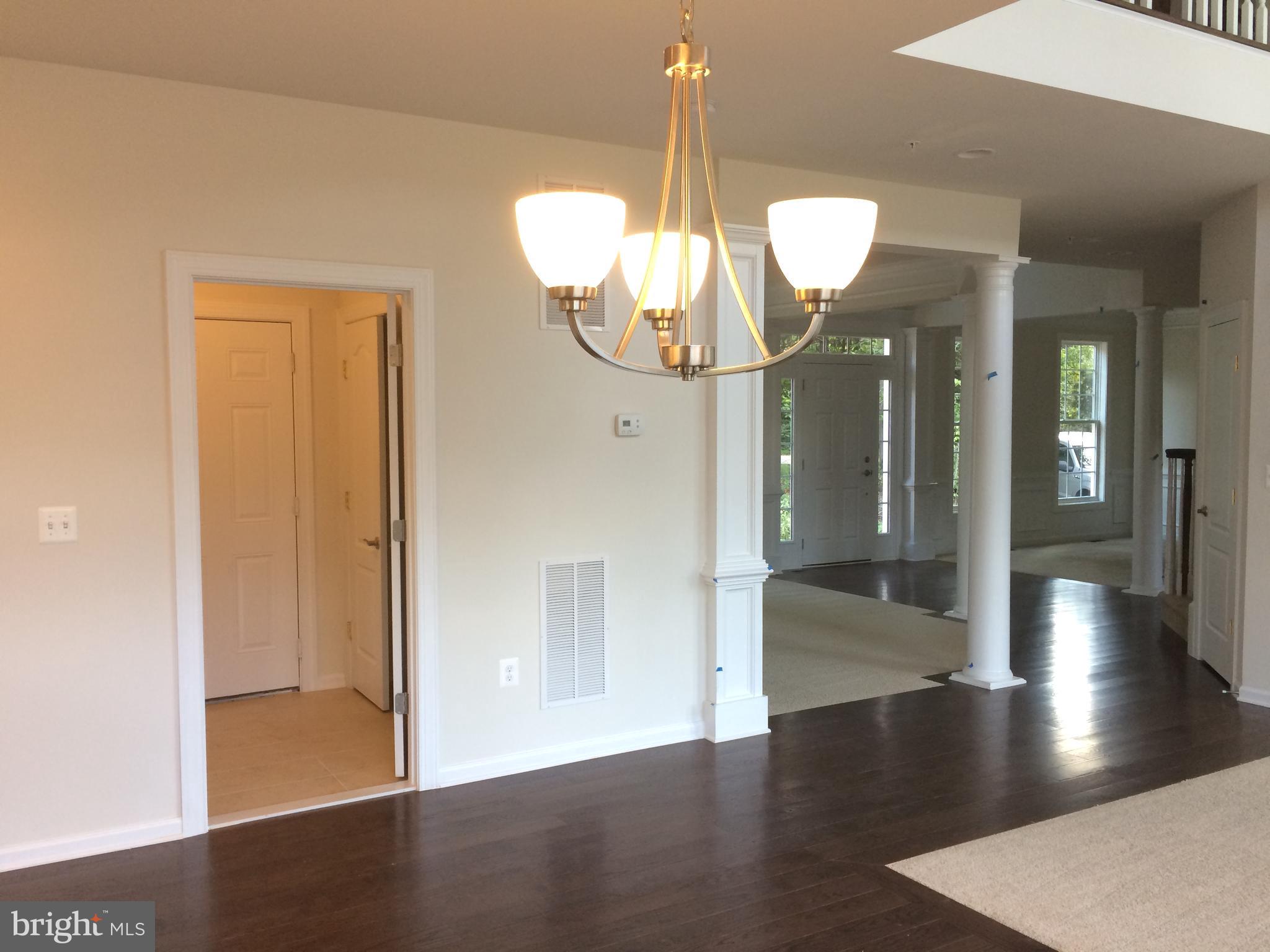 6510 Lawyers Hill Road Elkridge, MD 21075 - Photo 8 of 28 a view of a hallway with wooden floor and chandelier