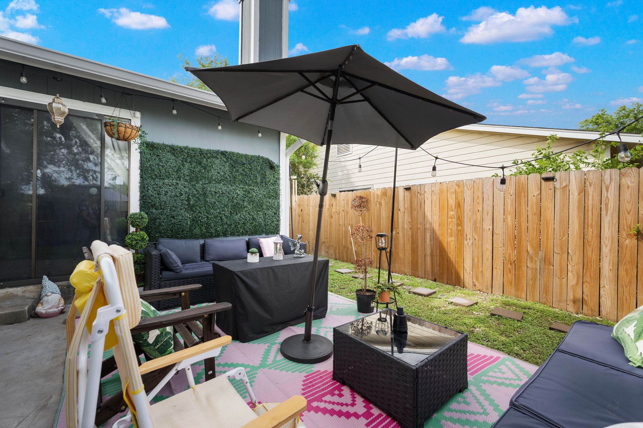 8317 Forest Ridge Drive San Antonio, TX 78239 - Photo 17 of 26 An inviting backyard oasis, perfect for outdoor living and entertaining, features a privacy fence and string lights.