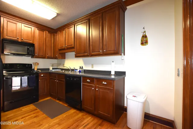 a kitchen with a sink cabinets and appliances