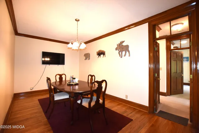 a dining room with furniture and wooden floor