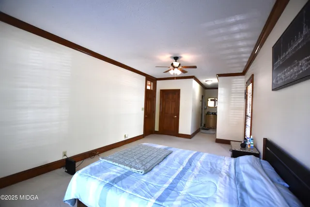 a view of a livingroom with hardwood floor and a ceiling fan
