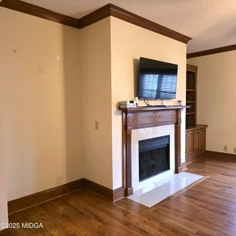 a living room with a fireplace and a flat screen tv