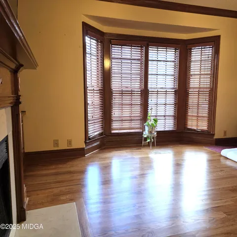 a view of a living room with furniture and wooden floor